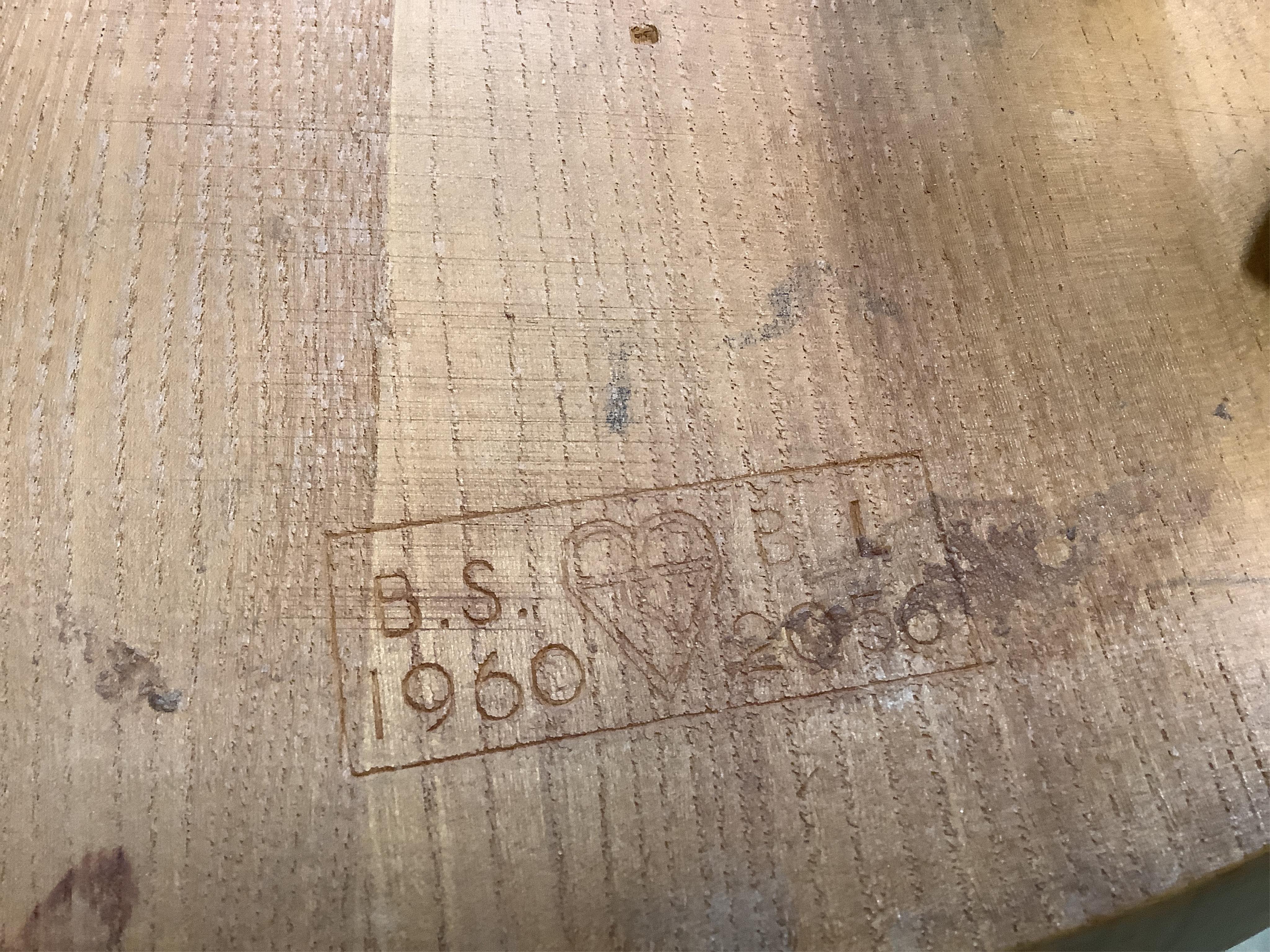 An Ercol rectangular elm dining table, width 150cm, depth 75cm, height 71cm together with six Ercol comb back dining chairs